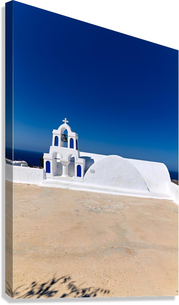 Traditional white and blue Greek church against a clear sky.