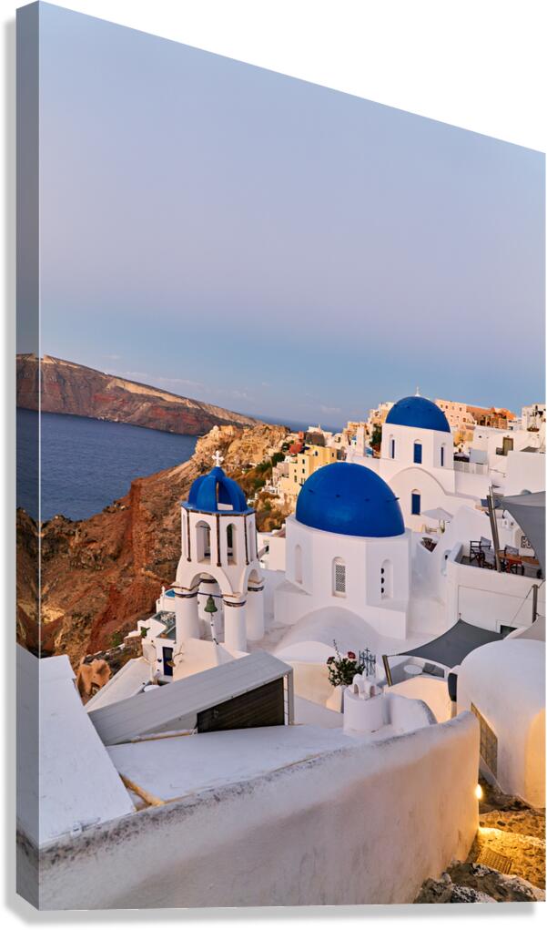 Picturesque Santorini village with blue domed churches and calde