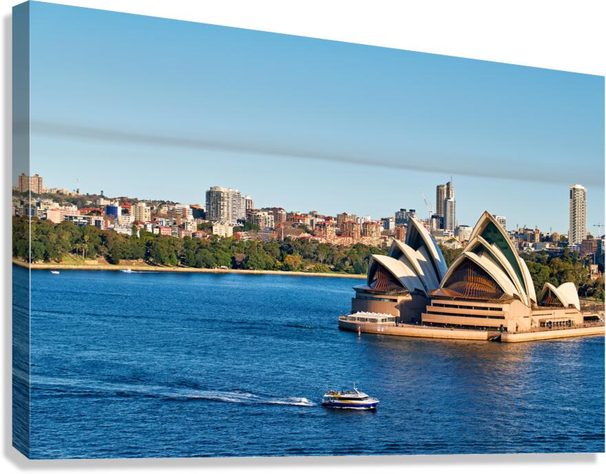 Sydney Opera House and harbor with ferry on a sunny day.