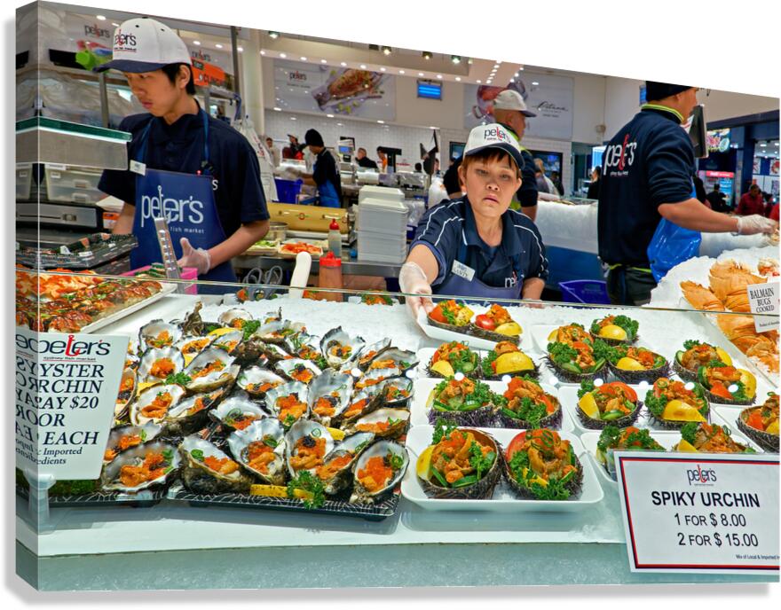 Fresh oysters and spiky urchin for sale at market.