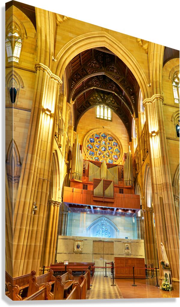 Interior of a grand cathedral with pipe organ and stained glass.