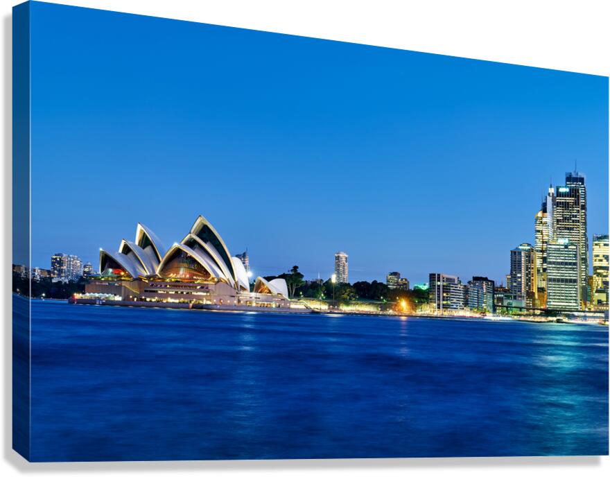 Sydney Opera House and city skyline at dusk.