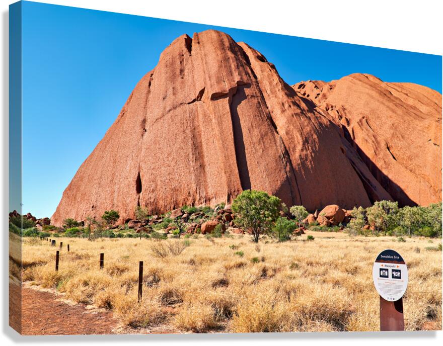 Uluru Australia a sacred monolith under a clear blue sky.