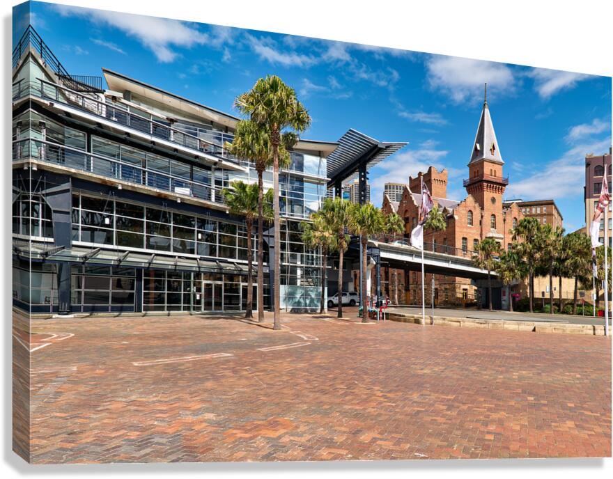 Modern building and historic tower by the water.