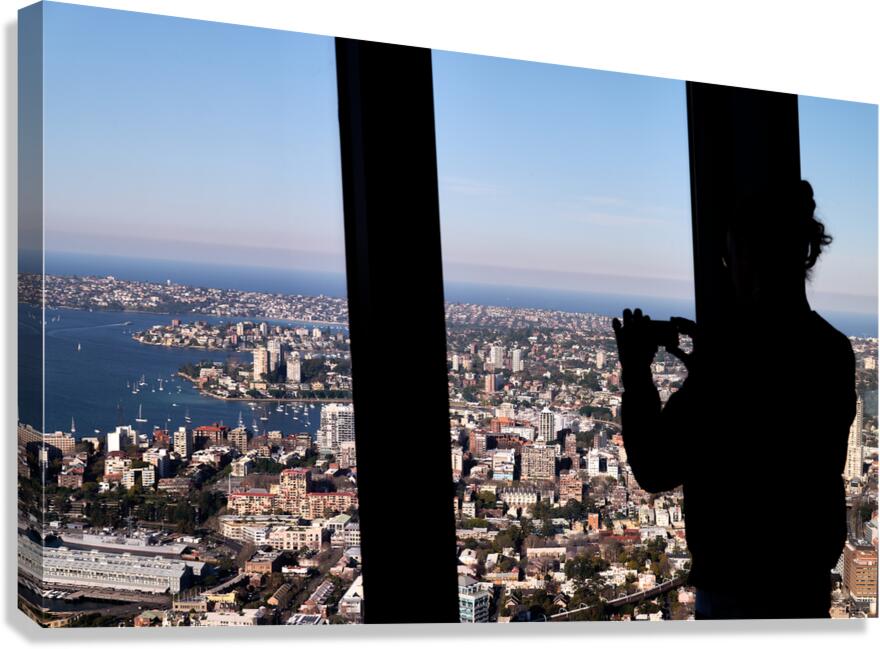 Silhouette of person taking photo of Sydney cityscape.
