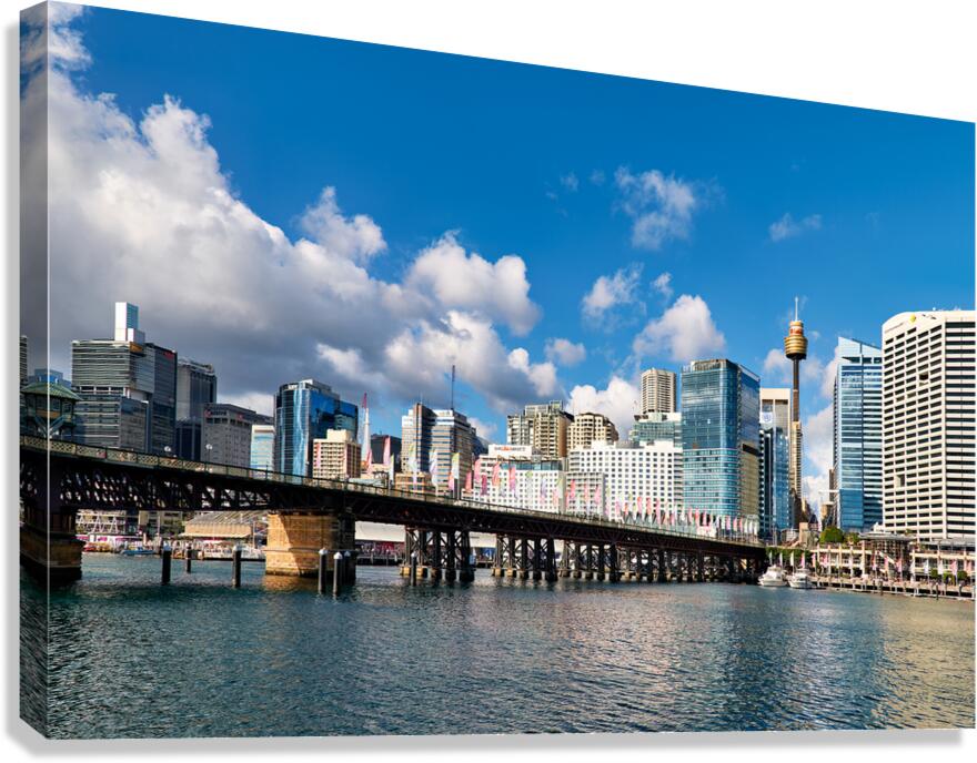 View of Sydney Harbour with bridge and city under blue sky