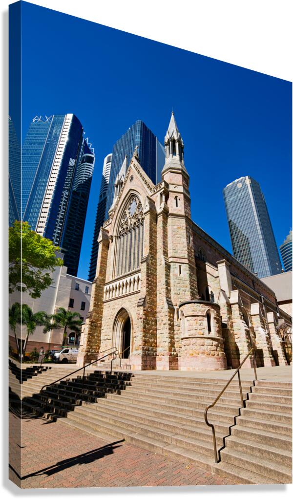 Historic church stands tall against modern skyscrapers.