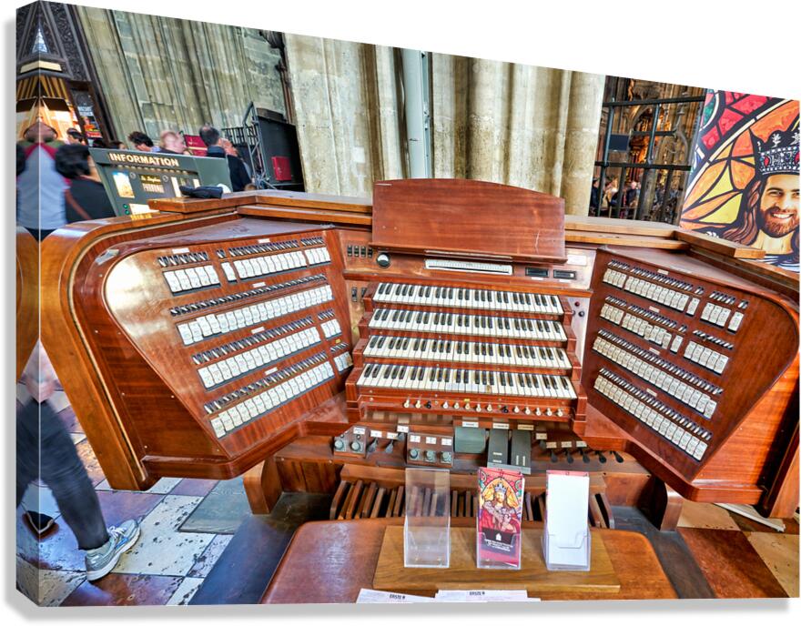 Intricate wooden pipe organ console with multiple keyboards and 