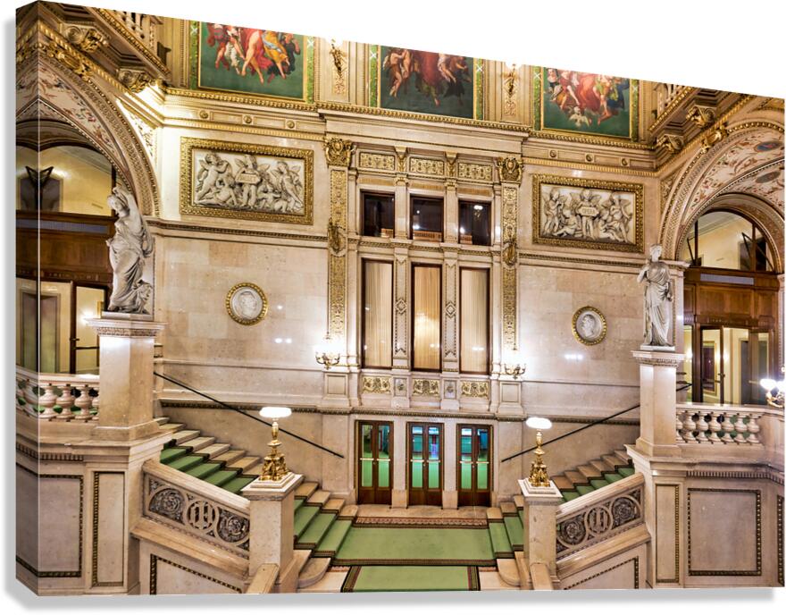 Grand ornate staircase inside a historic opera house.