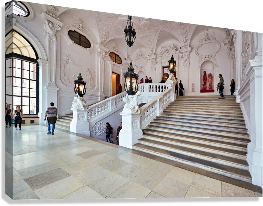 Visitors exploring a grand ornate staircase in a historic palac