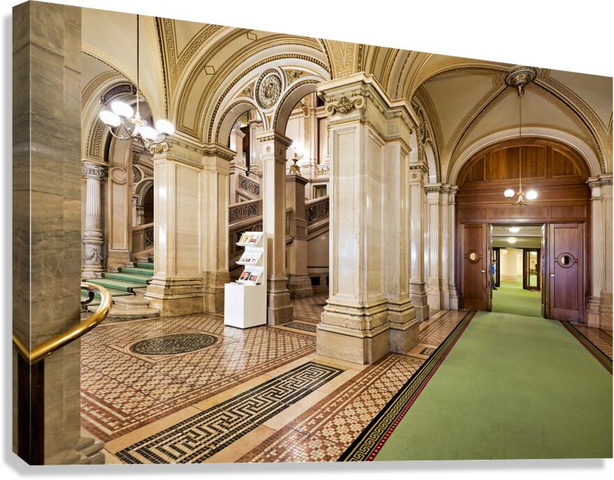 Ornate interior with grand staircase arches and patterned floo
