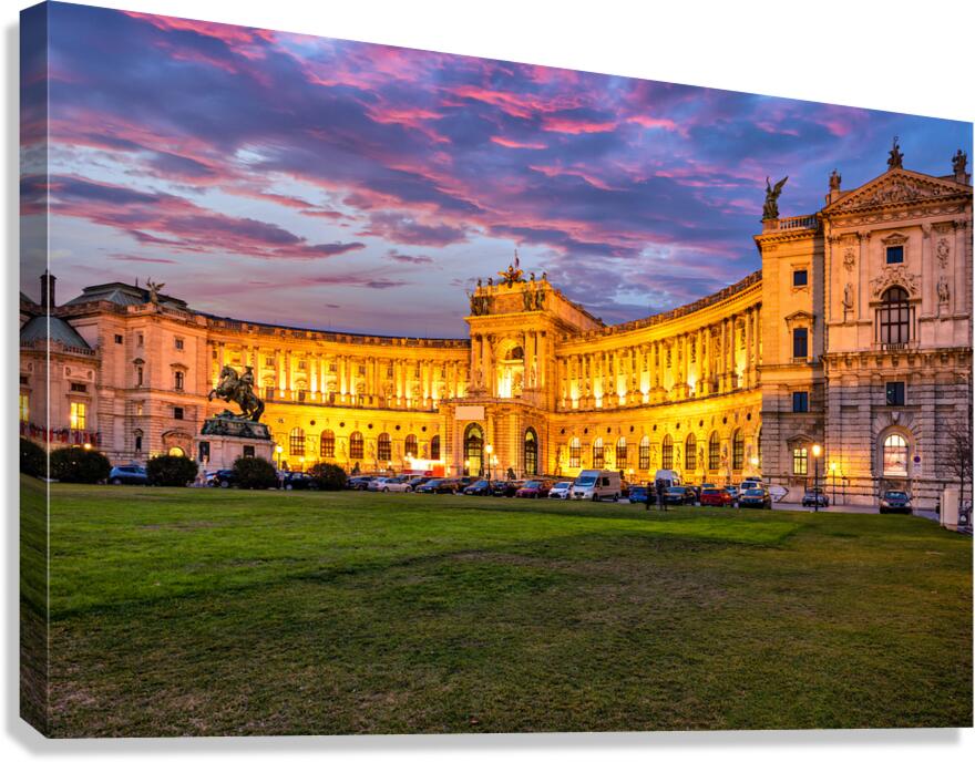 Illuminated Hofburg Palace in Vienna at sunset with vibrant sky.