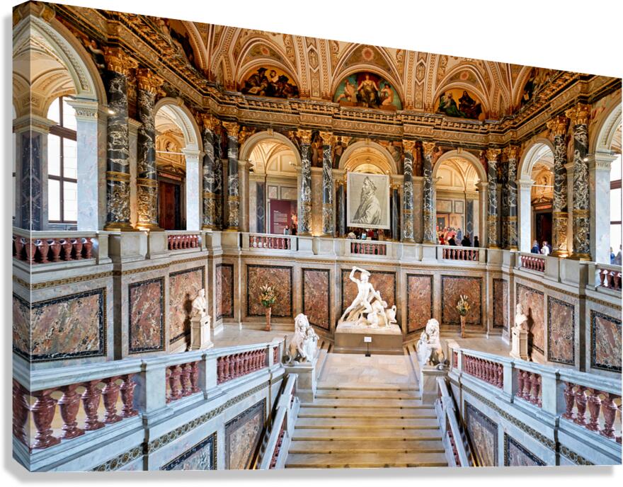 Grand ornate museum interior with staircase statues and paint