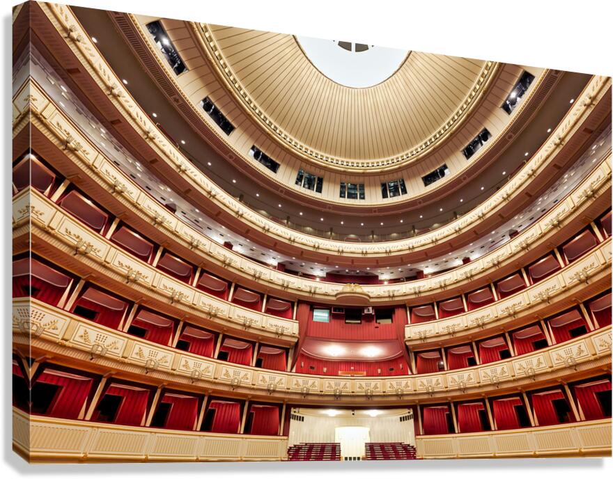 Ornate empty opera house interior with red velvet and gold deco