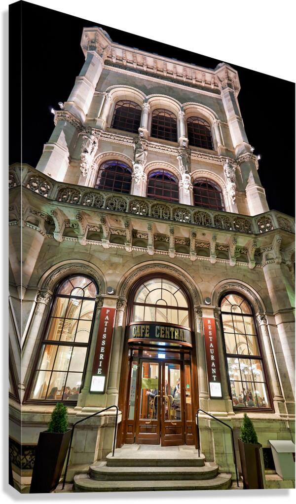 Grand Cafe Central building illuminated at night.