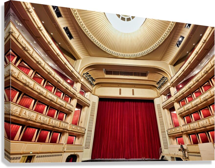 Grand opera house interior with red stage curtain and balconies.