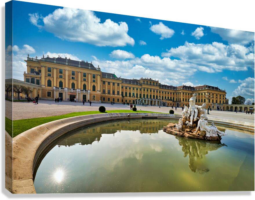 Schönbrunn Palace Vienna with Neptune Fountain and blue sky.