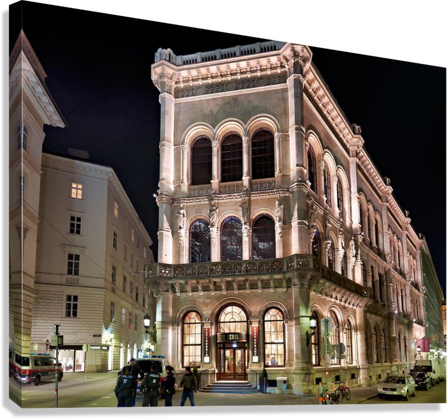 Viennas Cafe Central illuminated at night with police and peop