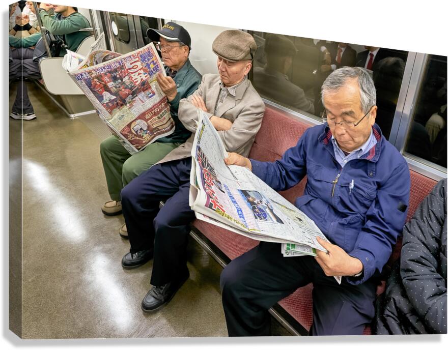 Tokyo subway commuters reading newspapers in the morning