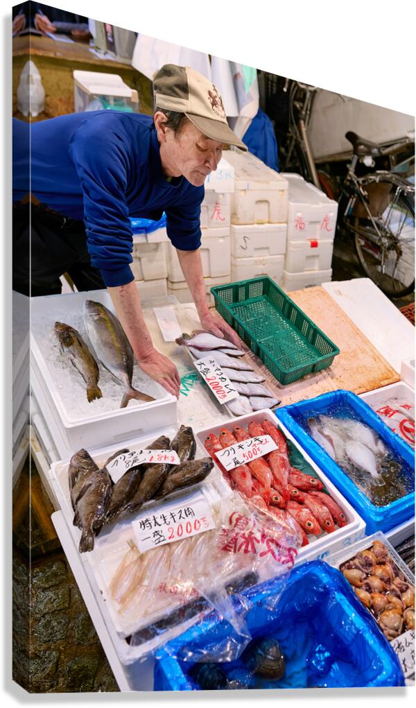 Fish market activity in Tokyo shows vendor and fresh seafood dis