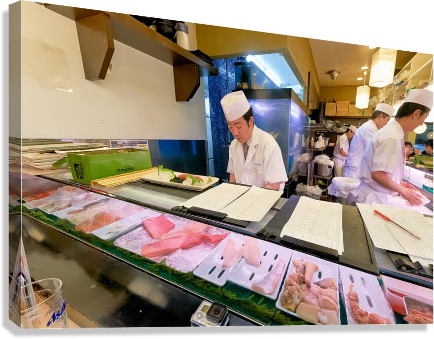 Sushi chefs preparing fresh dishes in Shibuya district of Tokyo