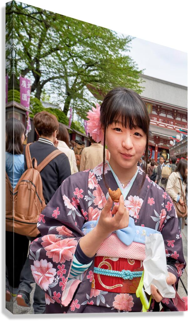 Girl tastes sweets in Asakusa streets of Tokyo during a busy day