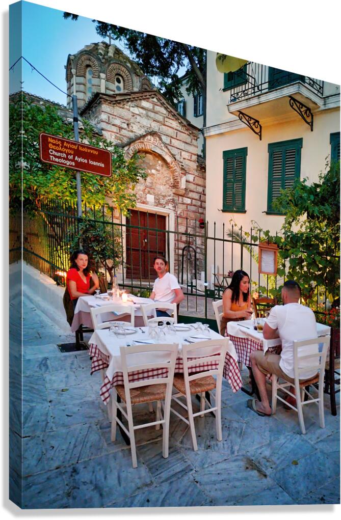 Dining in outdoor setting near church in summer evening