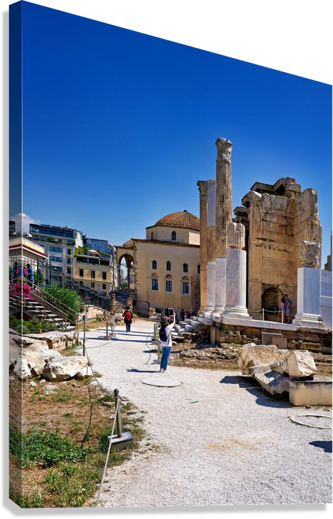 Visitors explore Hadrians Library in Athens Greece under clear
