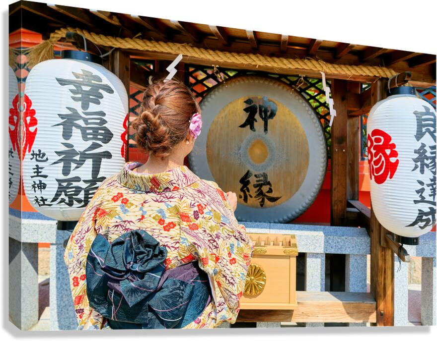 Young woman prays at Kiyomizu Dera Temple in Kyoto Japan