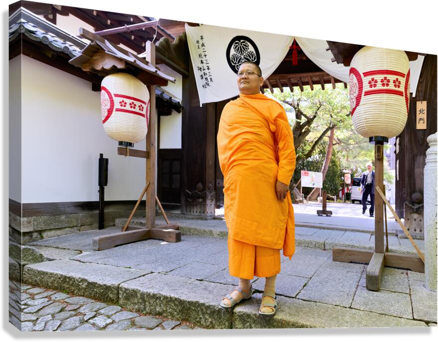 Monk stands at entrance of Chion in temple in Kyoto Japan