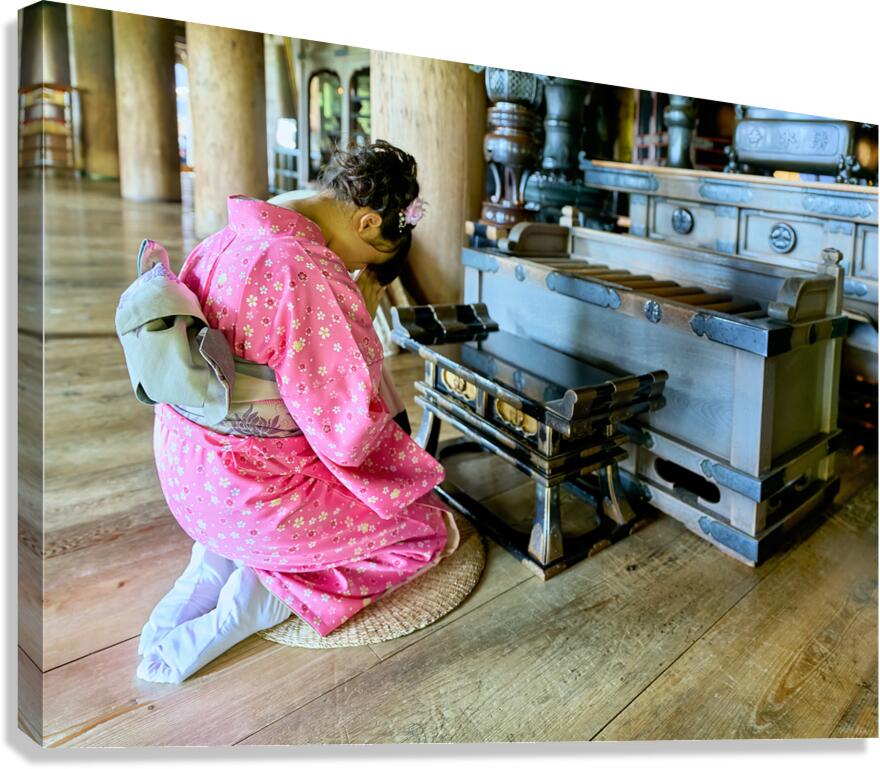 Kneeling in prayer at Kiyomizu Dera Temple in Kyoto Japan