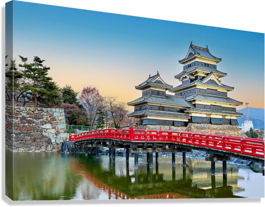 Matsumoto Castle at sunset by the water in Japan