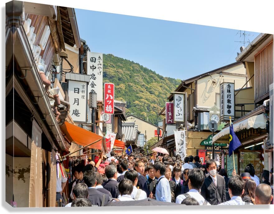 Crowds explore the Higashiyama district in Kyoto Japan on a sun