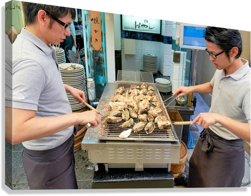 Grilling oysters at a restaurant in Miyajima Hiroshima Japan