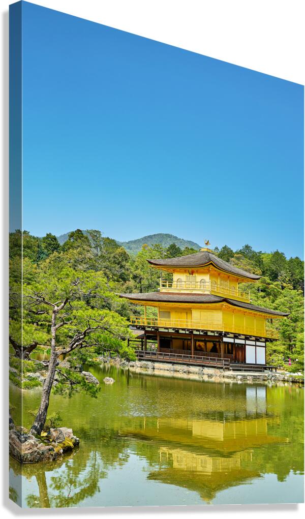 Kinkaku ji Temple reflects in water in Kyoto Japan on a clear da