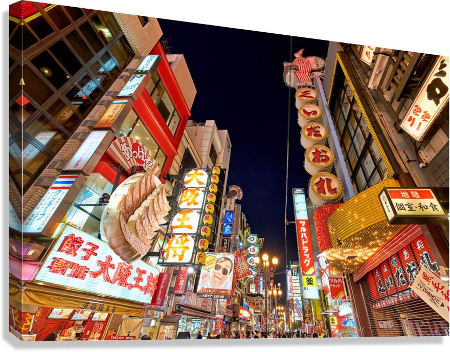 Illuminated signboards in Dotonbori District during sunset in Os