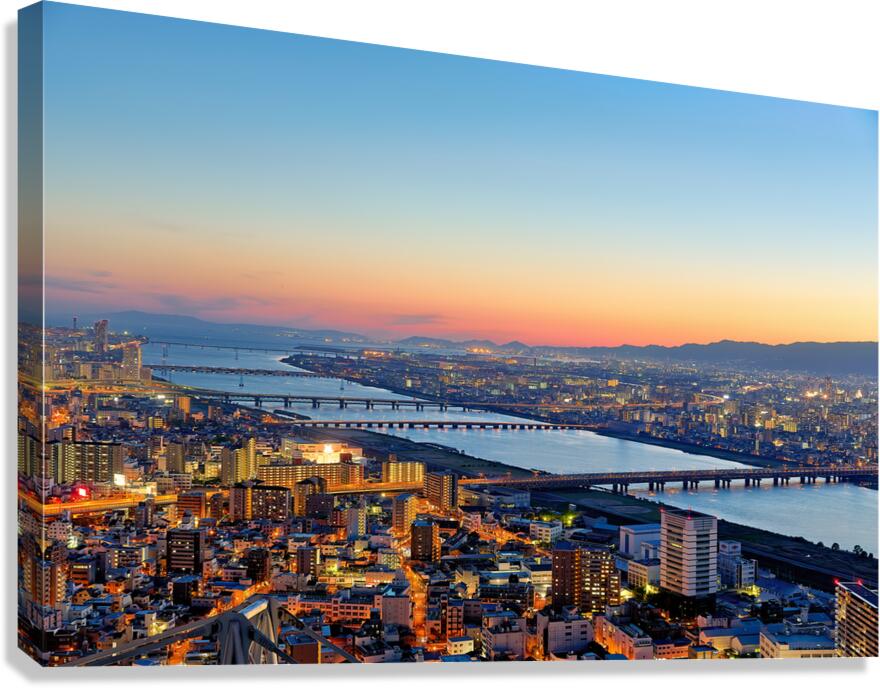 View of Yodo river in Osaka at sunset with city structures and r