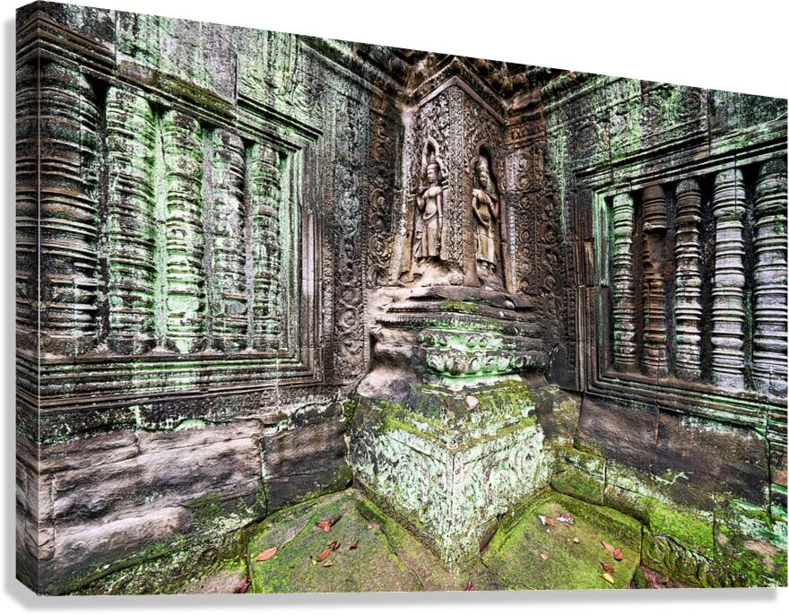 Ancient temple carvings covered in vibrant green moss.