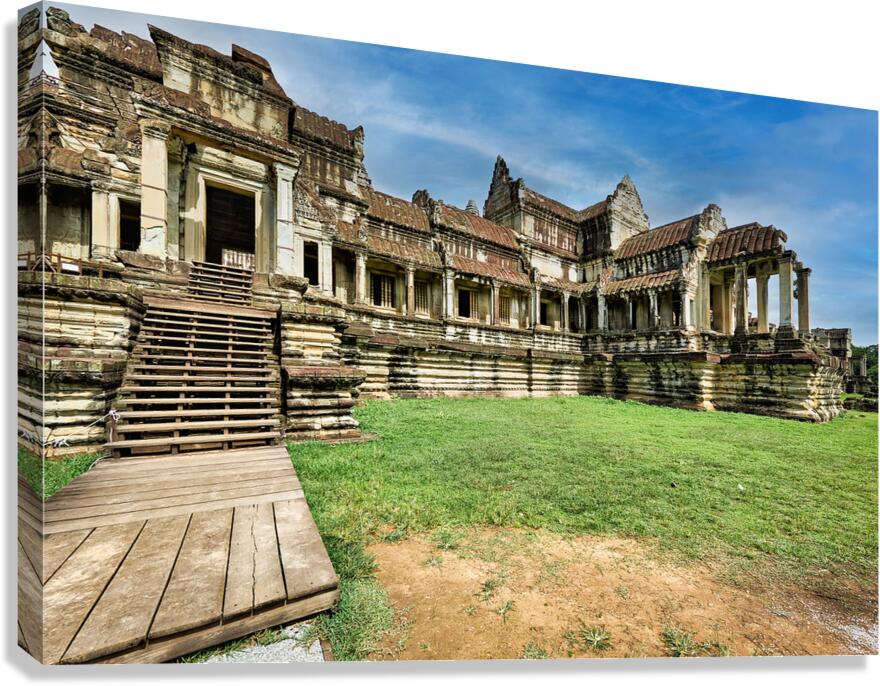 Ancient stone temple ruins wooden stairs green lawn blue sky.