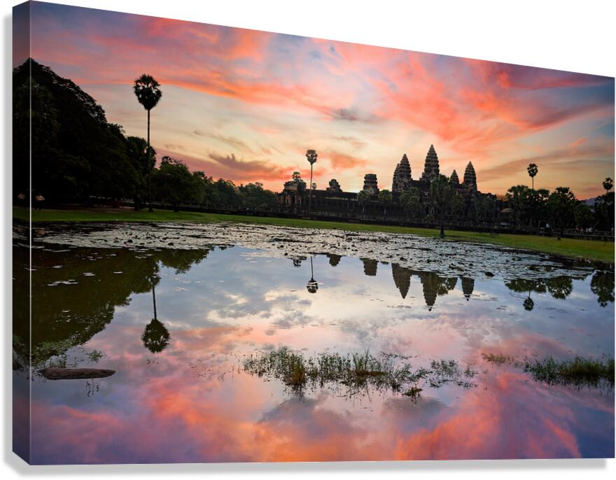 Stunning Angkor Wat sunset reflection over lily pond.