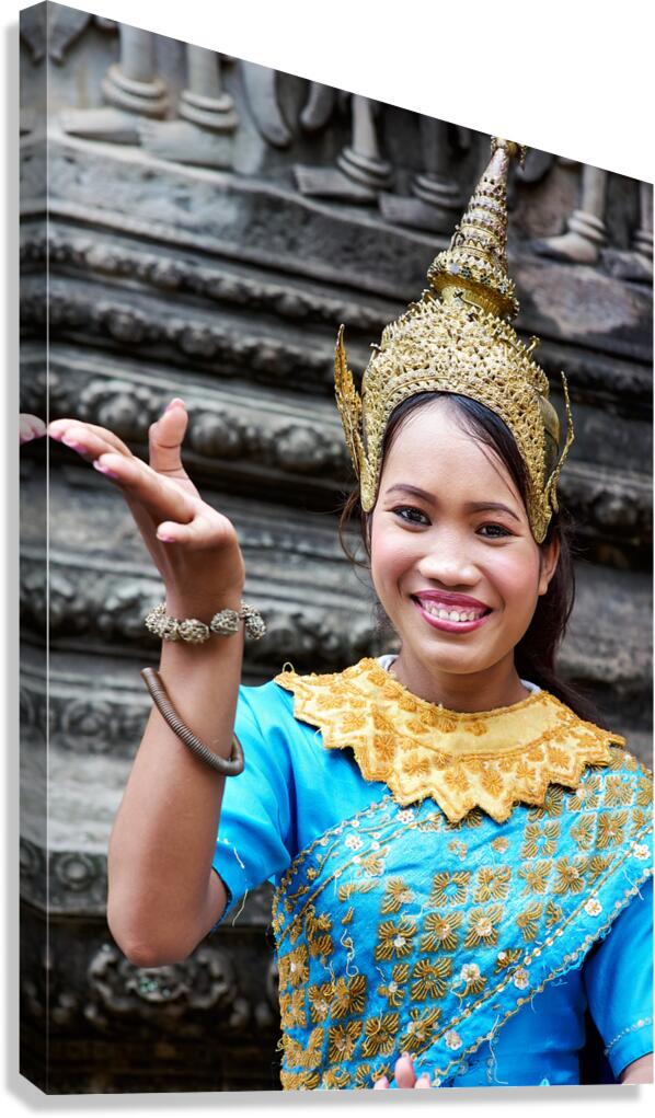Smiling Cambodian dancer in traditional blue and gold costume.