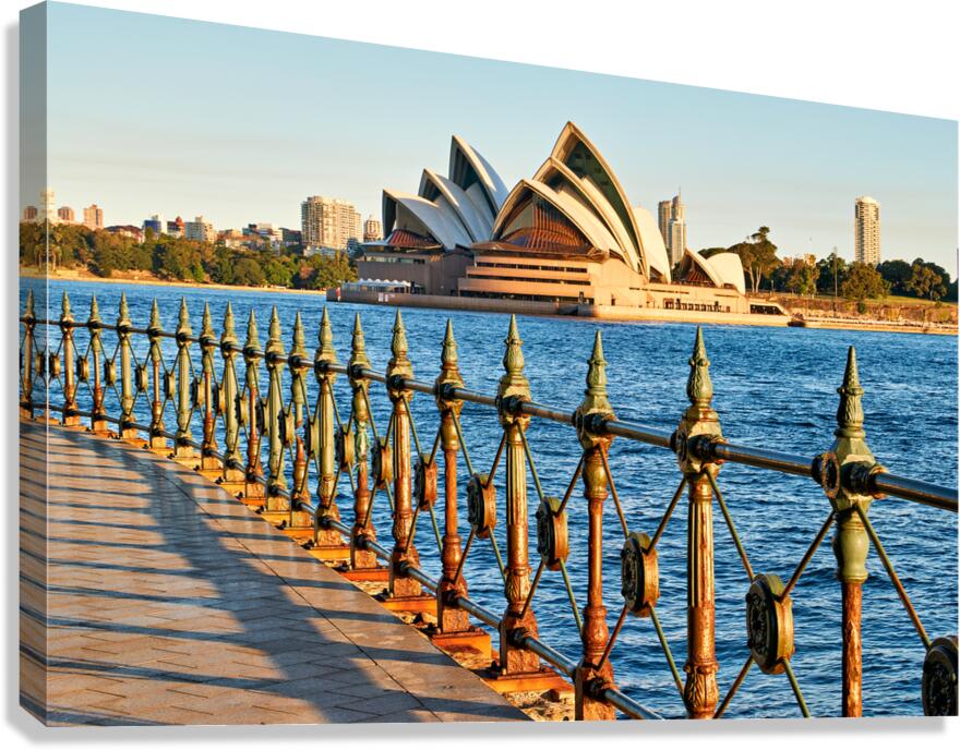 Sydney Opera House and harbor view at sunset.