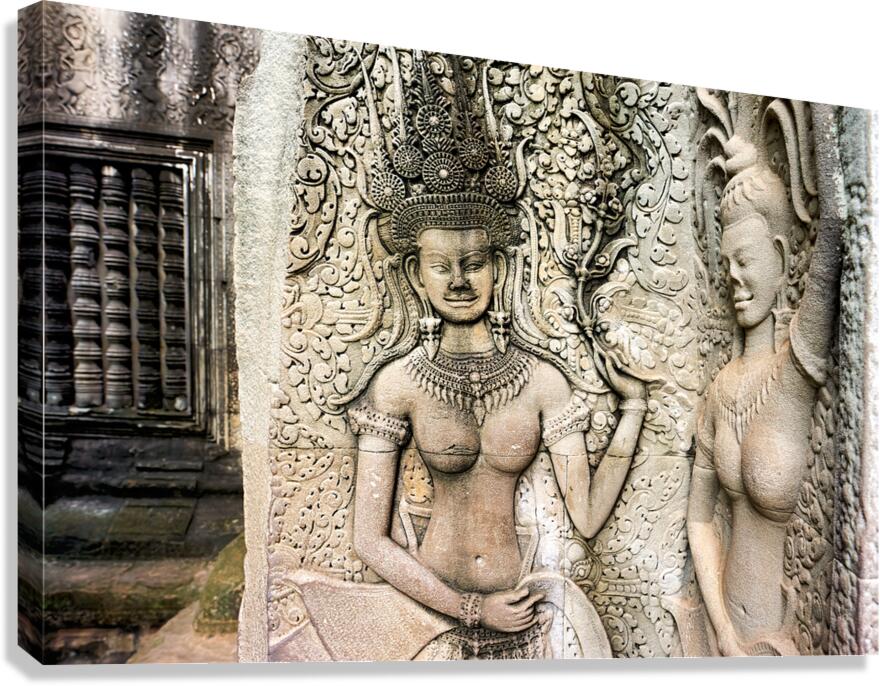 Angkor Wat temple wall with detailed Apsara stone carvings.