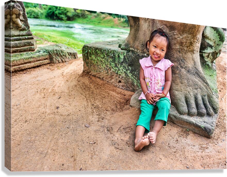 Smiling girl sits by ancient stone structure.