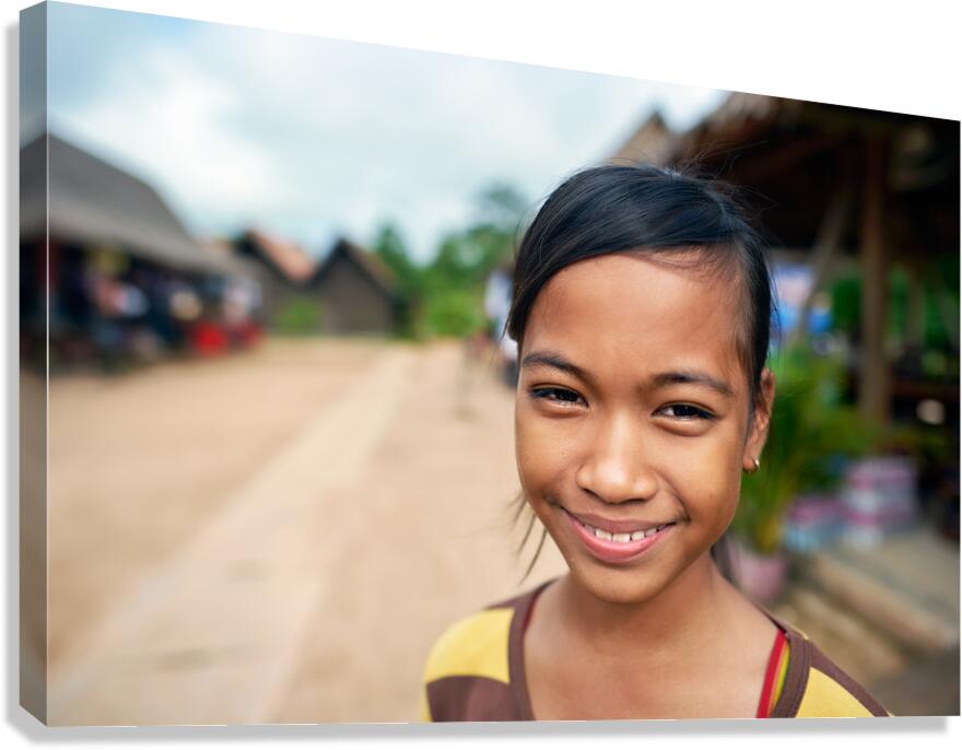 Smiling young girl in a village setting.