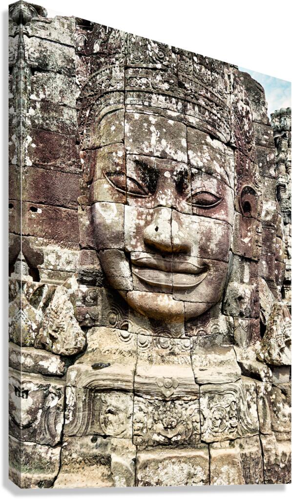 Ancient stone face carving at Bayon temple Cambodia.