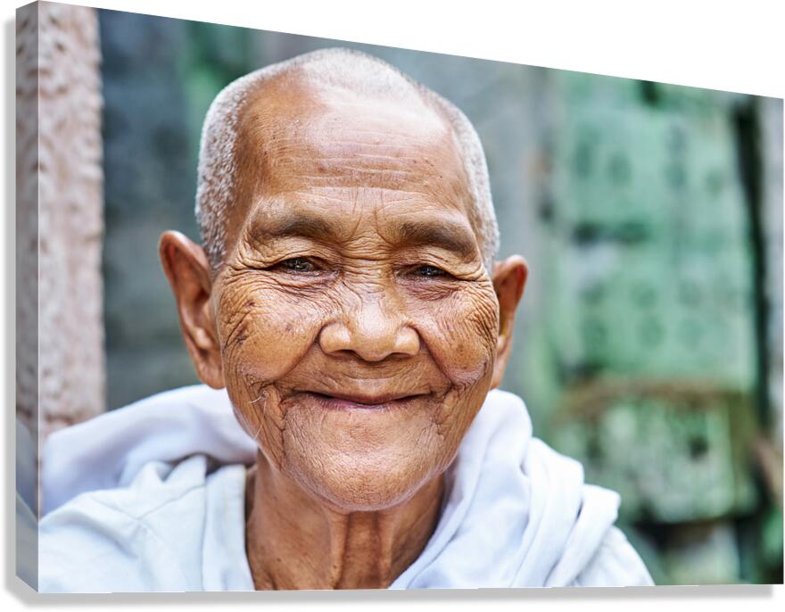 Smiling elderly Asian woman with shaved head.