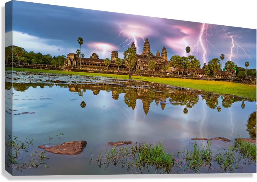 Lightning strikes over Angkor Wat reflected in water.