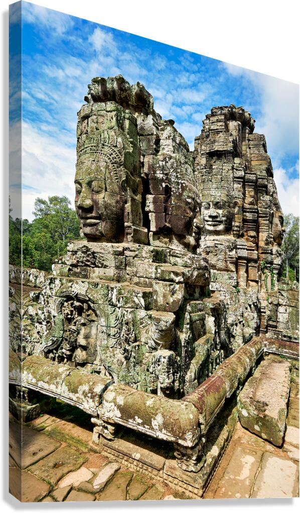 Ancient Khmer temple with carved stone faces.