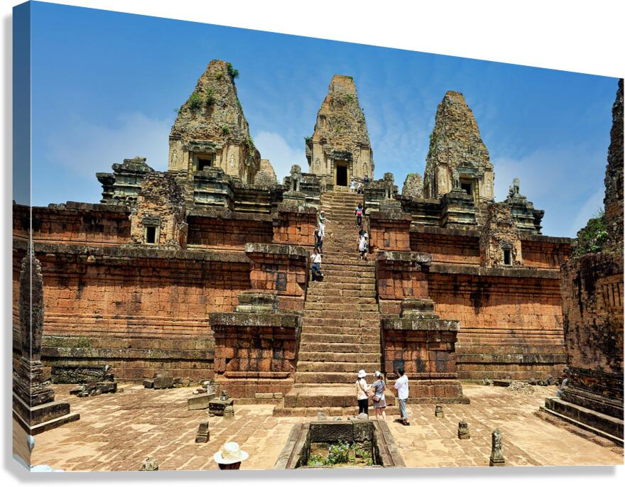 Tourists explore ancient Cambodian temple ruins.
